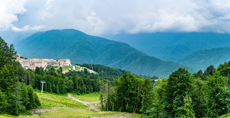 View of the hotel complex in the mountains covered with green forests