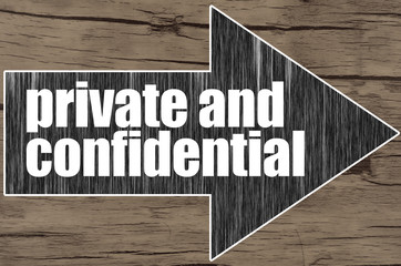 Arrow on wooden background written word Private and Confidential