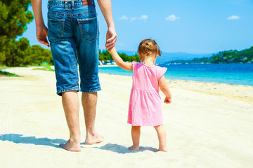 beautiful hands of parent and child by the sea