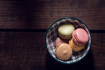 Macaroons on the wooden table