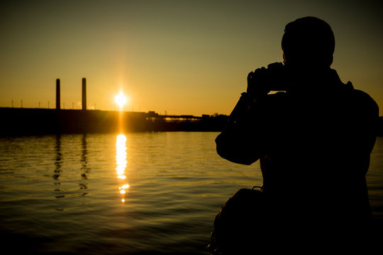 Man photographing sunset 