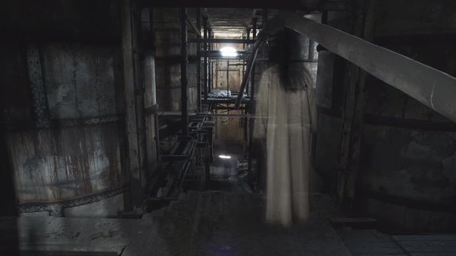 A ghost of a woman appears in the dark boiler room of an old factory.