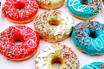 Delicious donuts with colorful chocolate
