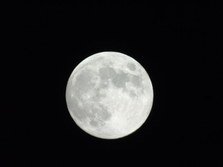 An amazing photography of the full moon over the city of Genova by night with a great clear sky in background and some stars