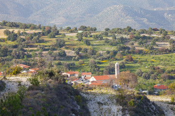 Fototapeta na wymiar Traditional rural greek scenic mountaine view, olives and other trees grow on slopes, houses with red roofs