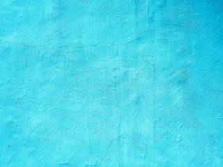 Old grungy turquoise painted vintage painted wall old paint with cracks background texture with...