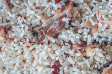 Typical Spanish meat and squid paella