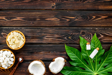 Organic cosmetics with coconut oil on wooden background top view mockup