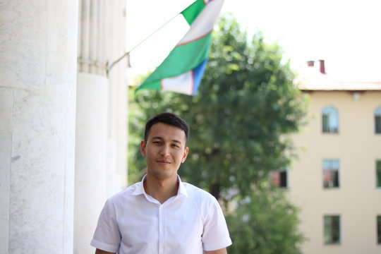 man on the background of the Uzbek flag