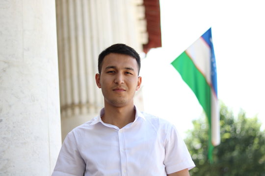 man on the background of the Uzbek flag