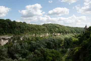 Fototapeta na wymiar Canyon, overgrown with forest, river at the bottom, cliff in Kamyanets-Podilsky, Ukraine