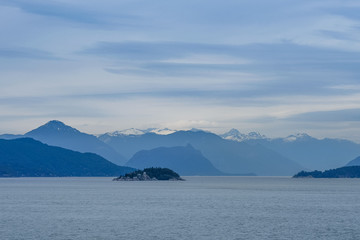 Breathtaking landscape in Alaska with mountains and blue sky. Panoramic view from the cruise ship in the USA.