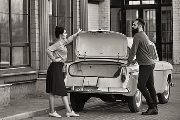 Couple in love near the car in retro style