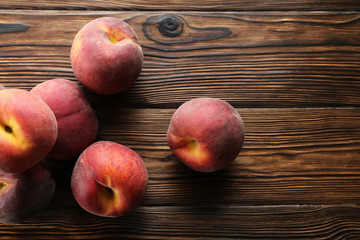 Bunch of ripe organic peaches in pile on textured table background. Local produce harvest heap on vintage style countertop. Clean eating concept. Top view, close up, copy space for text.