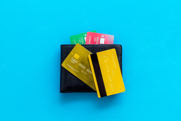 business with credit cards and wallet on office desk blue background top view