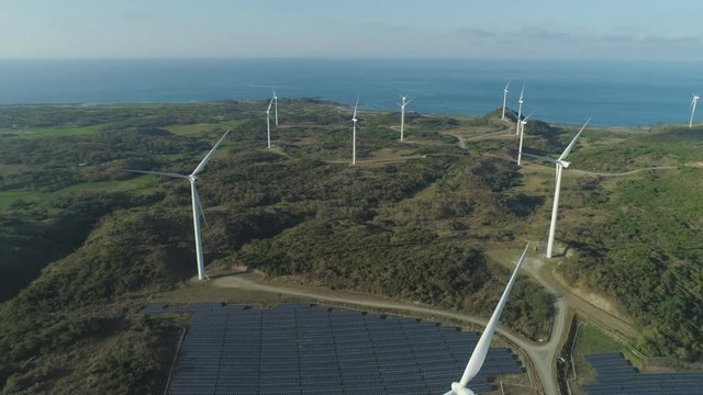 Aerial view of wind turbines, Windmills for electric power production on the seashore. Bangui Windmills in Ilocos Norte, Philippines. Solar farm, Solar power station. Ecological landscape: Windmills