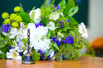 Bell. Bouquet on September 1. Classroom. The beginning of the school year. School board in the background.