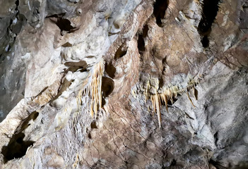 Stalactites in the cave as background