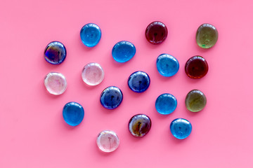 Bright stones on pink background top view