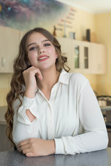 Fototapeta premium Back to school and happy time. Cute teenage girl is sitting at a desk indoors. Student is learning in class