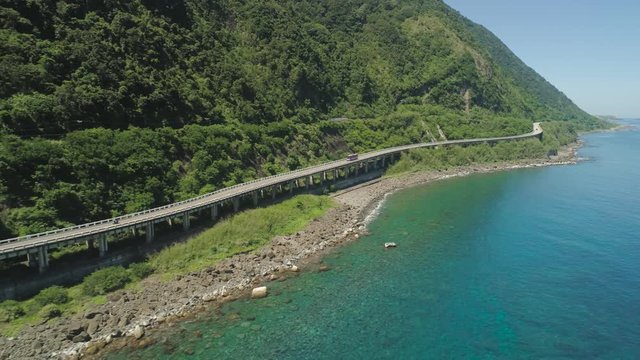 Aerial view of Patapat viaduct in the coast of Pagudpud, Ilocos Norte. Highway with bridge by coast sea near the mountains. Philippines, Luzon.