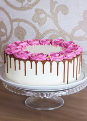 Celebratory cake with cream roses and chocolate