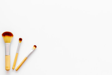 Instruments for make up with brushes on white background top view mock up