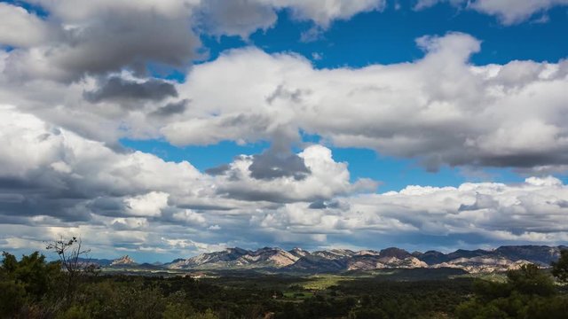 Clouds move swiftly over the rugged landscape of Beget, Tarragona, Spain, highlighting the picturesque scenery and natural beauty