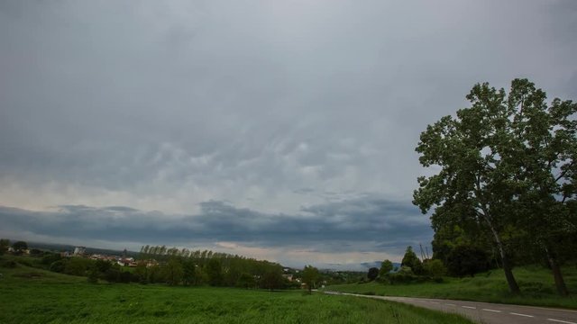 Timelapse of storm clouds forming over a rural road in Osona, Barcelona, Spain
