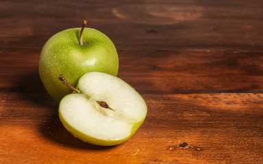 two apples one cut in half