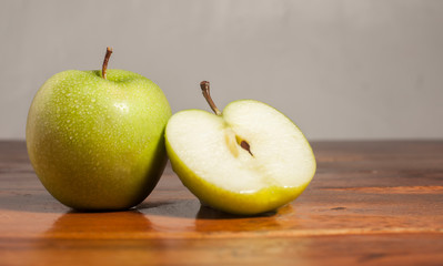 two apples one cut in half