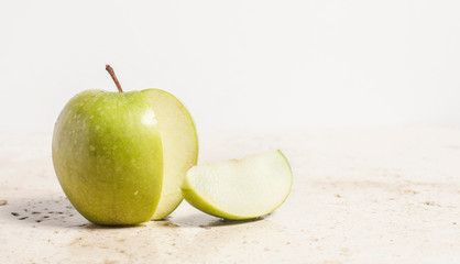 Apple with small slice on white background