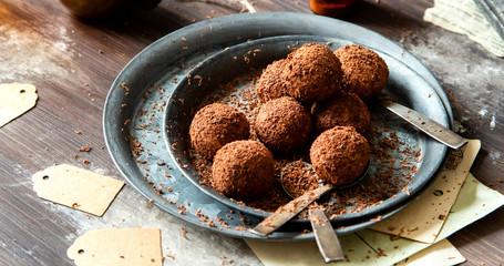 homemade truffle candy in two metal vintage plates with chocolate flakes