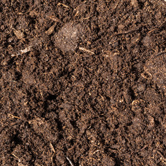 Brown crushed peat, fertilizer and soil component - background for agriculture