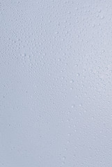 big and small water drops on grey background