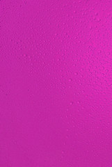 big and small water drops on pink background