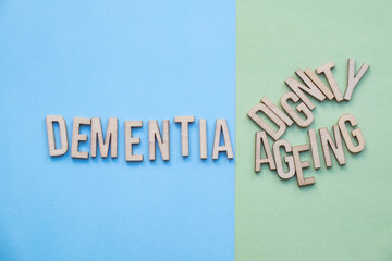 Dementia concept, word spelled out with dignity and ageing 