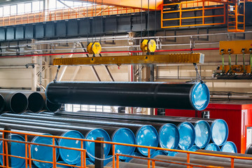 Polymer coated pipe transportation by overhead crane in warehouse