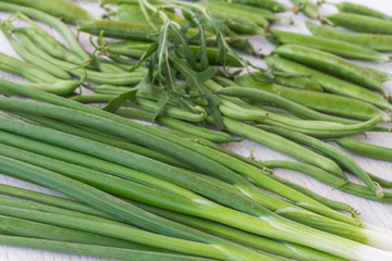 A set of green vegetables: onions, peas, top view