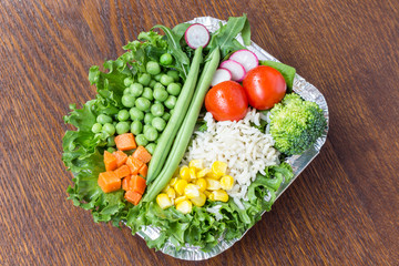 A set of vegetables with rice for a healthy diet: corn, peas, asparagus, carrots, broccoli, lettuce
