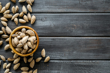 Almond in bowls for cooking on wooden background top view mockup