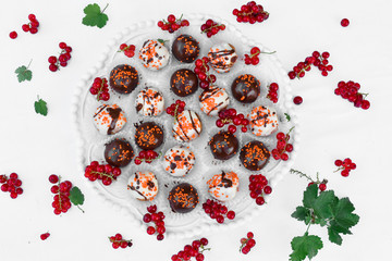 Chocolate and cookie based dessert balls with ribes.