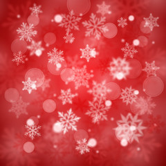 Christmas blurred background of complex defocused big and small falling snowflakes in red colors with bokeh effect