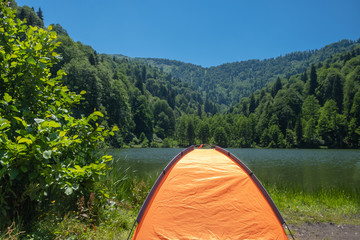 Camping tent at scenic campsite on a lake