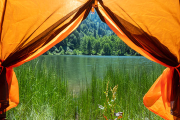 Camping tent at scenic campsite on a lake