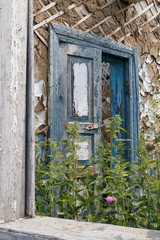Old door in an abandoned rustic wooden house.