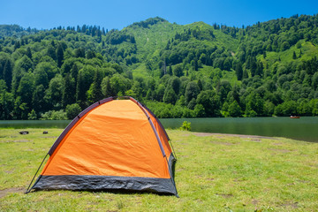 Camping tent at scenic campsite on a lake