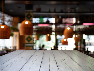 vintage wooden table on blurred cafe background dining room restaurant