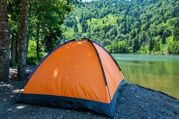 Camping tent at scenic campsite on a lake