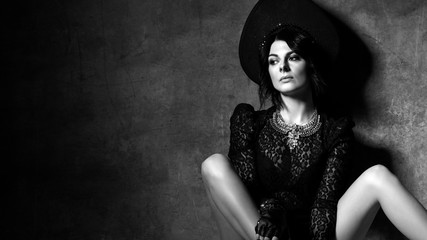 Black and white. Sensual sexy woman in stylish neofolk clothes lingerie and kokoshnik sitting in...
